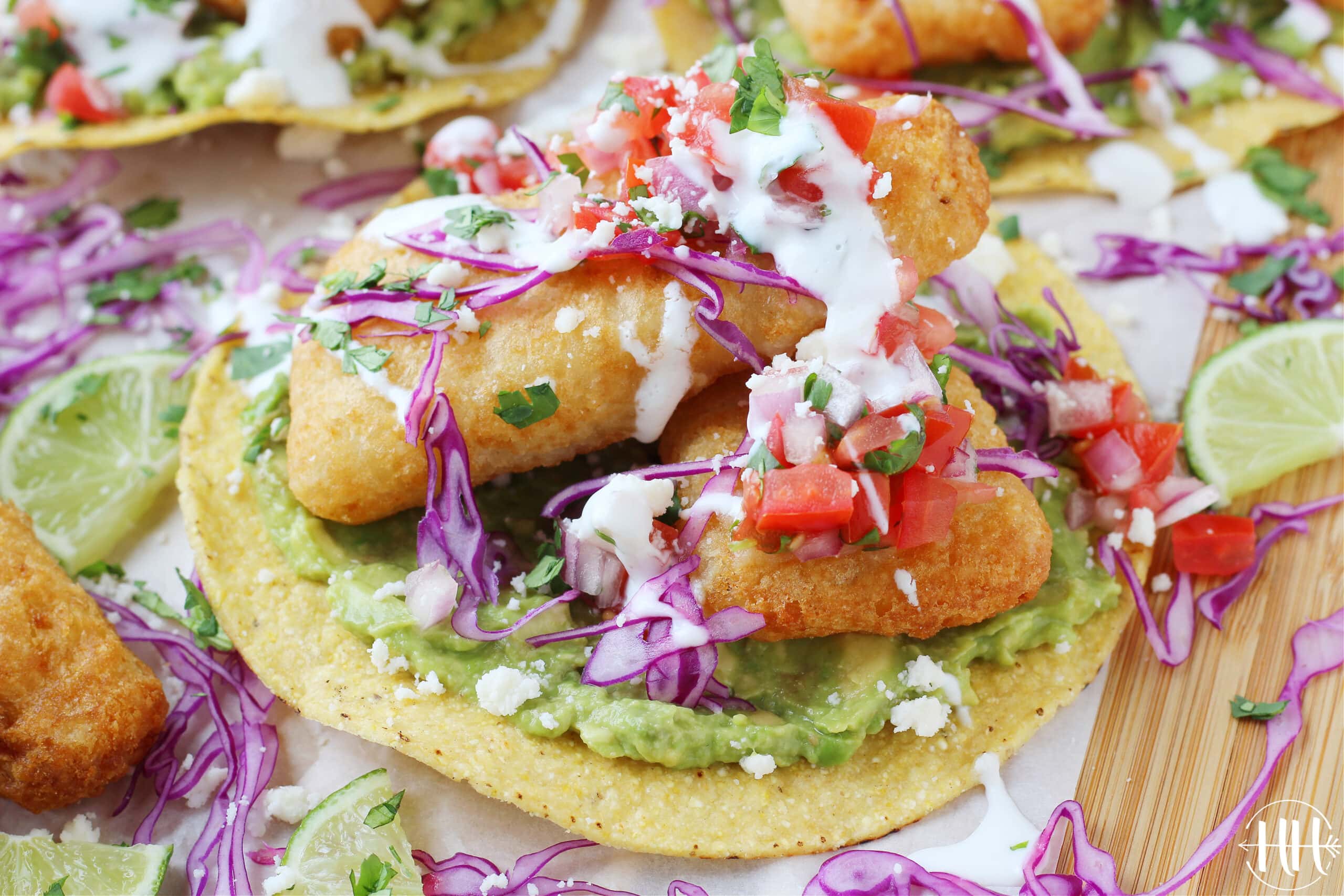 Pico de gallo, crumbled queso fresco, purple cabbage and fish filets on a tostada shell.