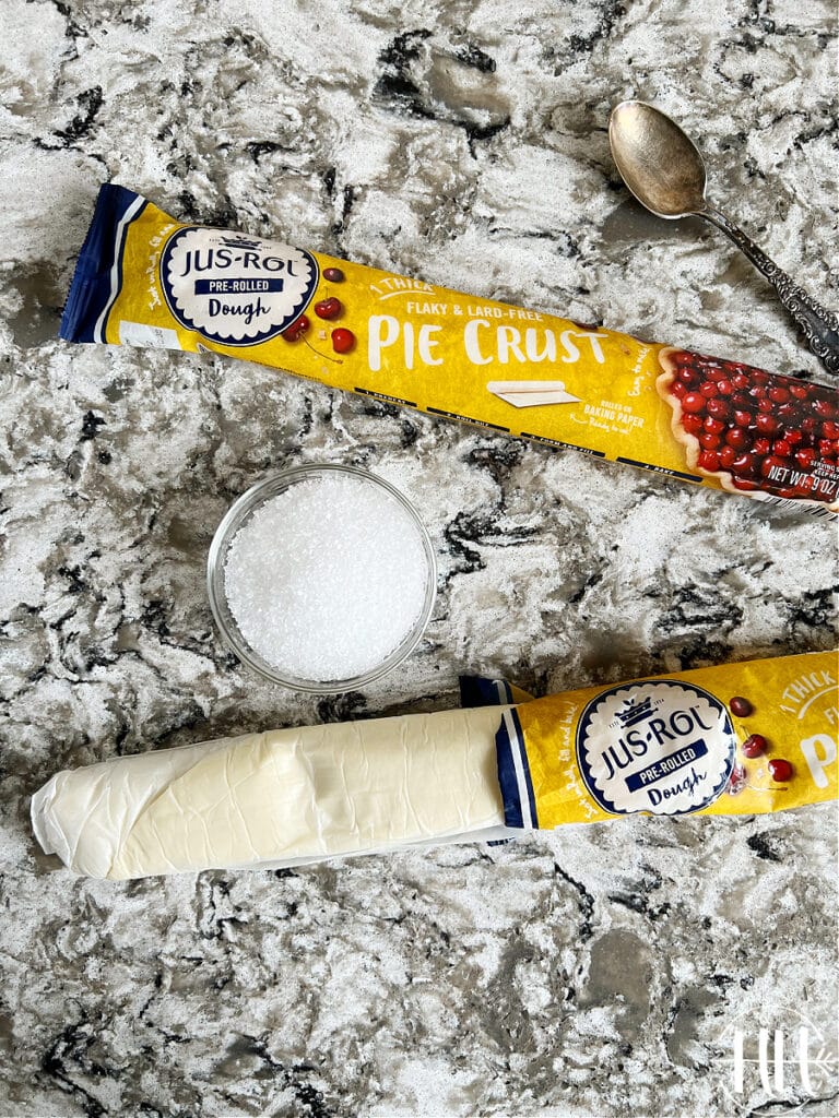 Two Jus Rol pie crusts on a Cambria quartz counter top ready to be used for fruit crostatas.