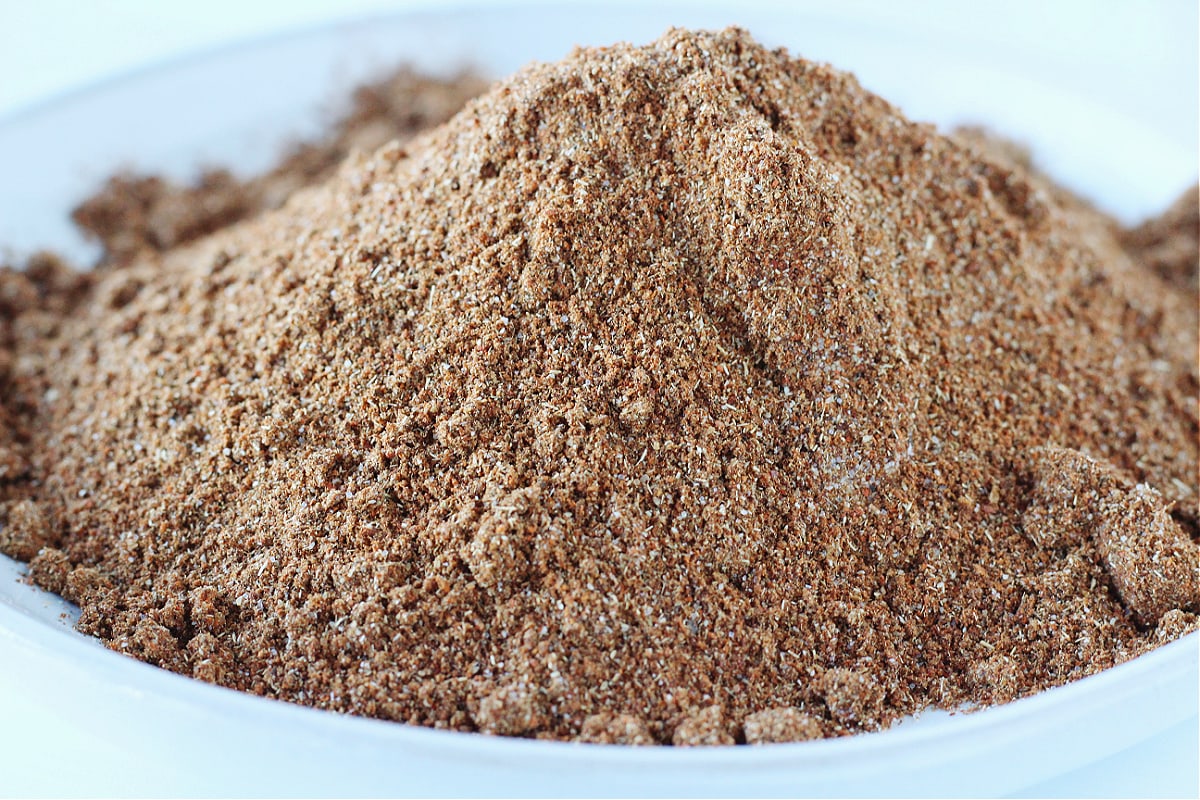 Up close photo of DIY taco seasoning piled high on a white plate.