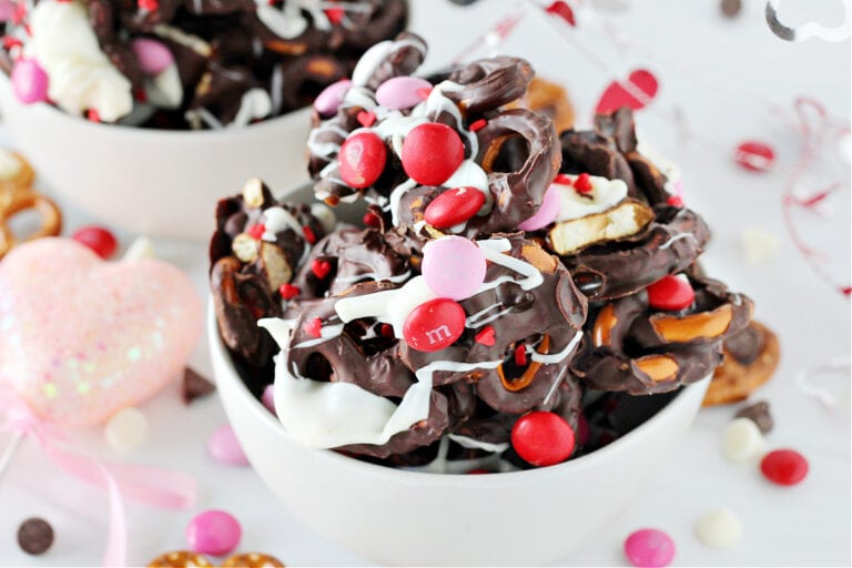 Valentine's Day Chocolate Pretzel Bark in a white bowl with pink and red M&Ms.