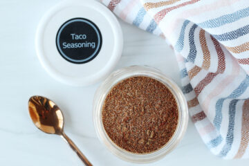 Overhead photo of homemade taco seasoning mix in a jar with labeled lid.