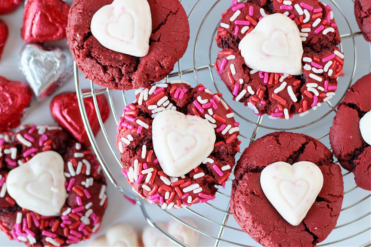 Overhead photo of red velvet cake mix cookies on a metal cooking rack.