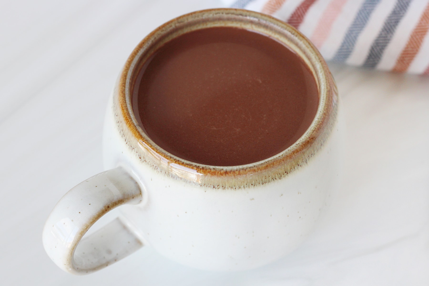 Up close photo of healthy bone broth hot cocoa in a small mug.