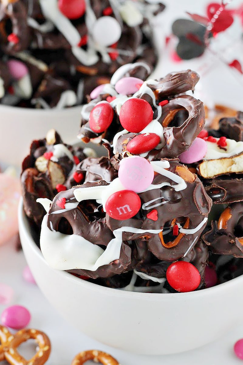 Side view of Valentine's chocolate pretzel bark drizzled with white chocolate and M&Ms.