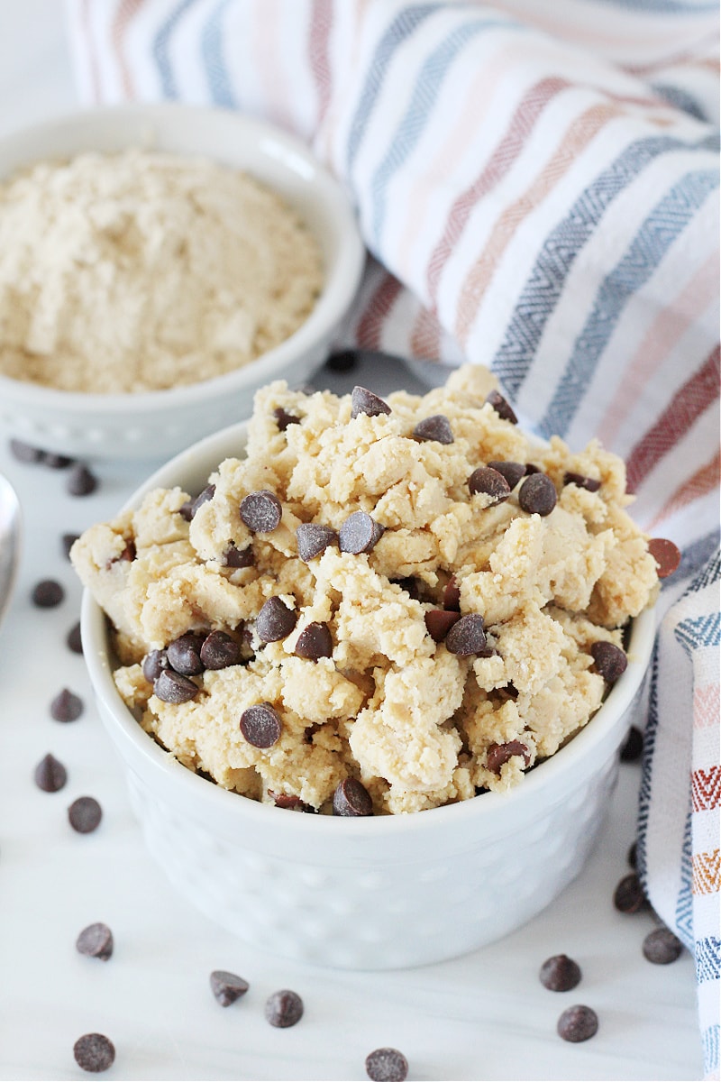 Easy edible cookie dough with protein powder in a bowl topped with chocolate chips.