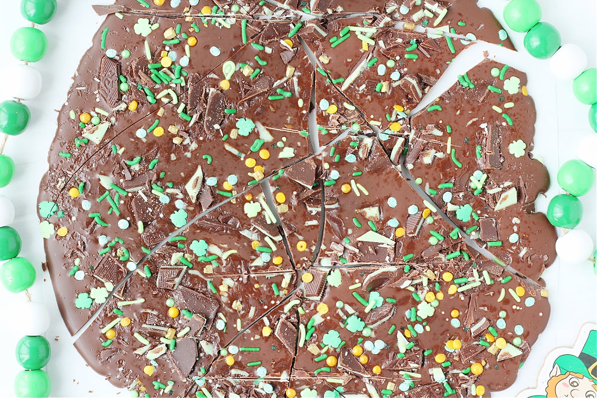 Overhead photo of Easy Leprechaun Bark cut into pieces on a white countertop.