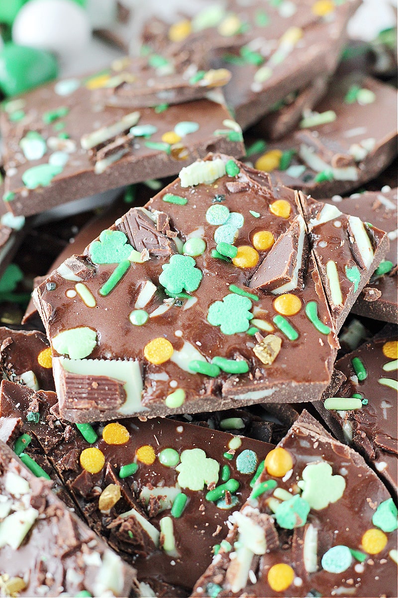 A piece of Easy Leprechaun Bark studded with St. Patrick's Day sprinkles and Andes Mints.