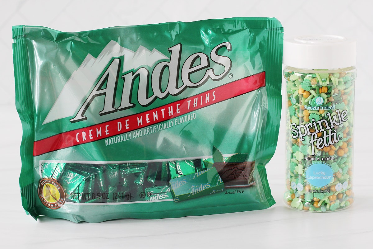 A bag of Andes Mint thins and a container of Lucky Leprechaun sprinkles.