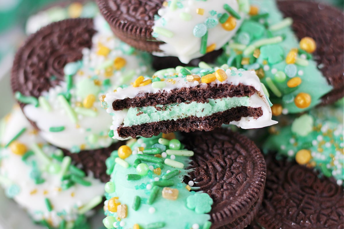 Up close photo of a St. Patrick's Day Oreo cookie with a bite taken out.