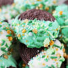 Up close photo of a green chocolate dipped Oreo cookie with St. Patrick's sprinkles.