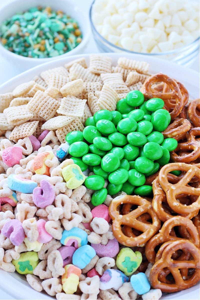 Twisty pretzels, Chex cereal, Lucky Charms cereal, and green M&Ms for a Leprechaun Bait recipe.