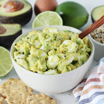 4 Ingredient Avocado Egg Salad in a white bowl surrounded by individual ingredients.