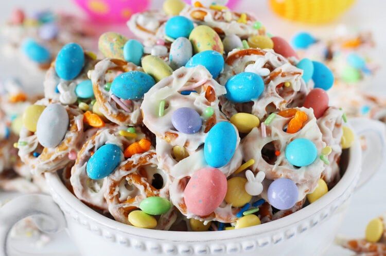 Easter Pretzel Bark in a white bowl with pastel chocolate Robin Eggs candies.