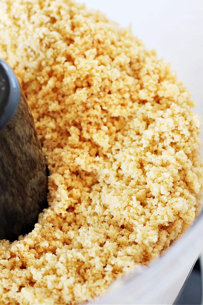 Up close photo of lemon Oreo crumbs in a food processor.