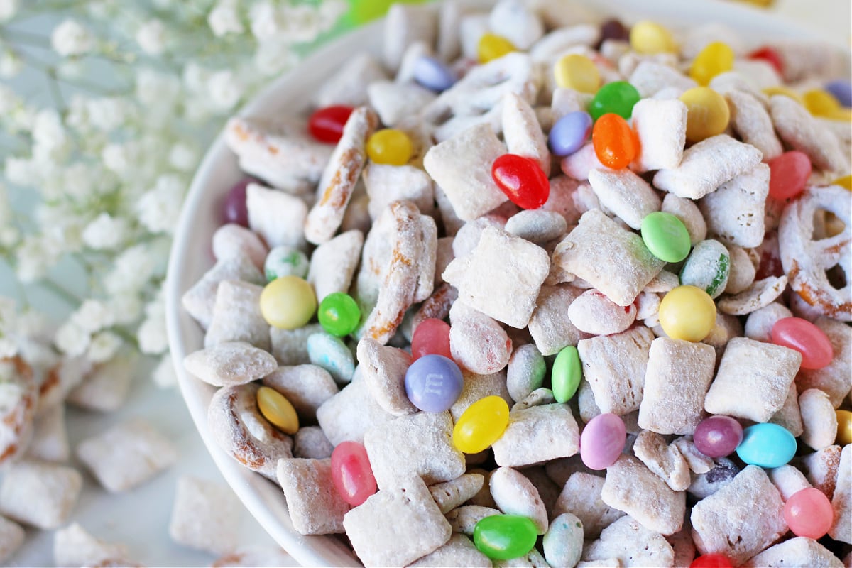 Easter Bunny Bait in a white bowl with powdered sugar pretzels and jelly beans.