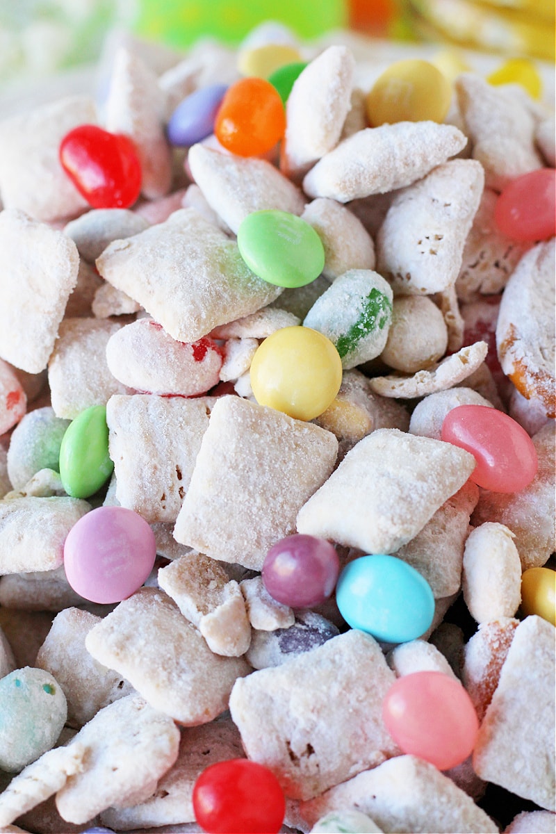 Up close photo of Easter Puppy Chow with pastel M&Ms and colorful jelly beans.
