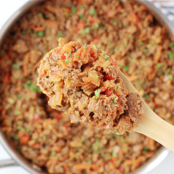 Overhead photo of a wooden spoon with healthy sloppy joes on it over the pan.