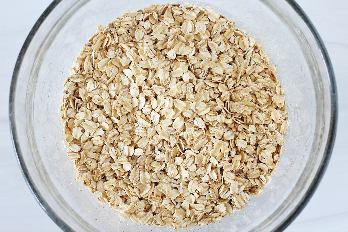 Overhead photo of old fashioned oats in a glass mixing bowl.
