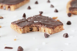 Up close photo of a piece of high protein cookie dough bark with chocolate chips.