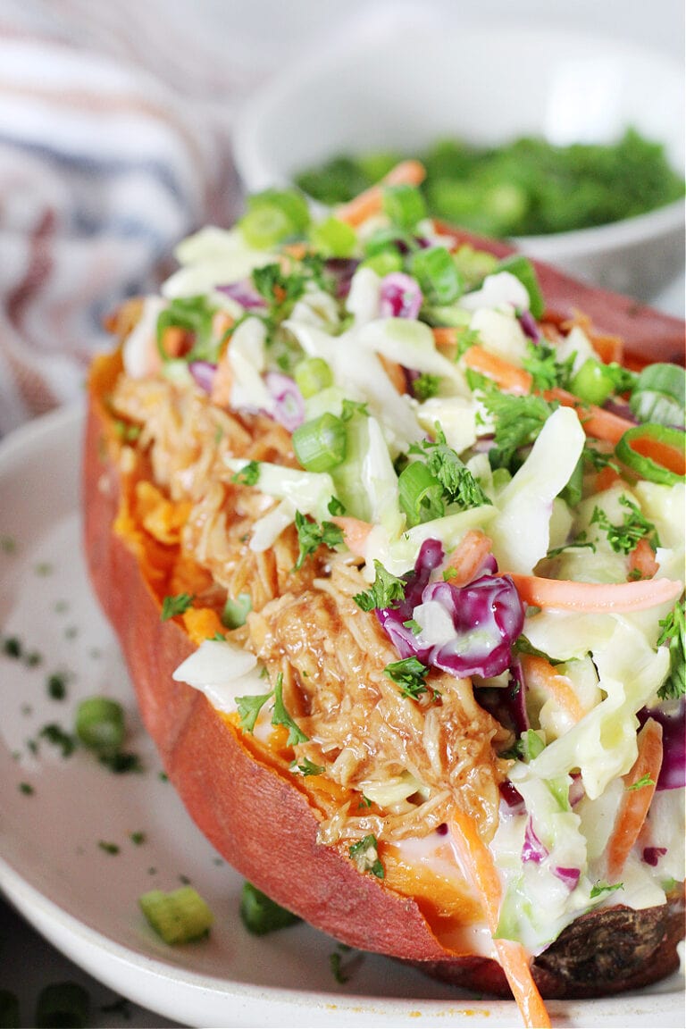 A sweet potato stuffed with bbq chicken and coleslaw.