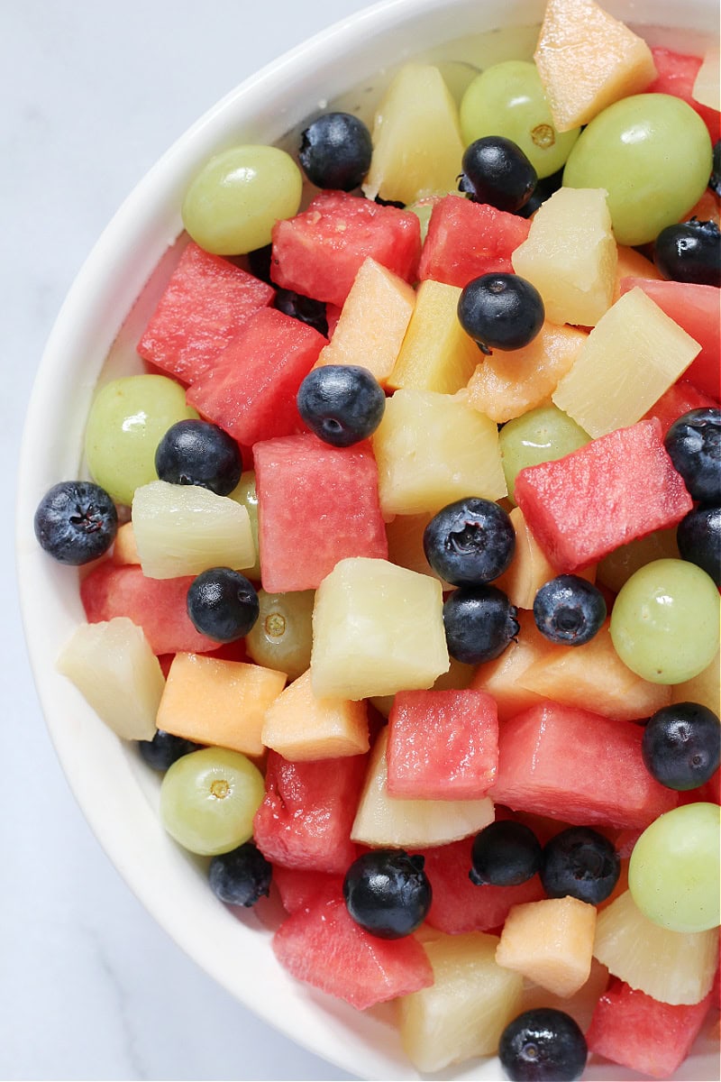 Overhead photo of half of a bowl filled with fresh fruit salad.