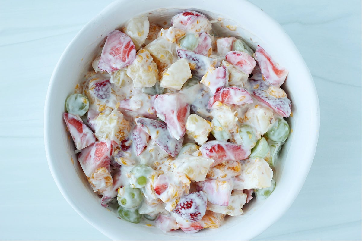 A bowl of coconut Hawaiian fruit salad coated in low sugar Greek yogurt.