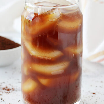 A tall glass of homemade cold brew with ice cubes.