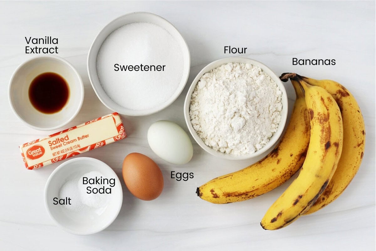 Ingredients for gluten free banana muffins on a white marble countertop.