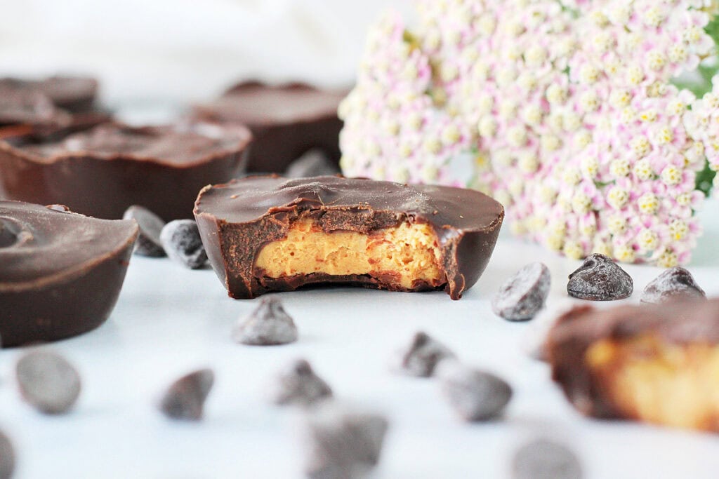 Up close photo of a protein Reese cup with a bite taken out.