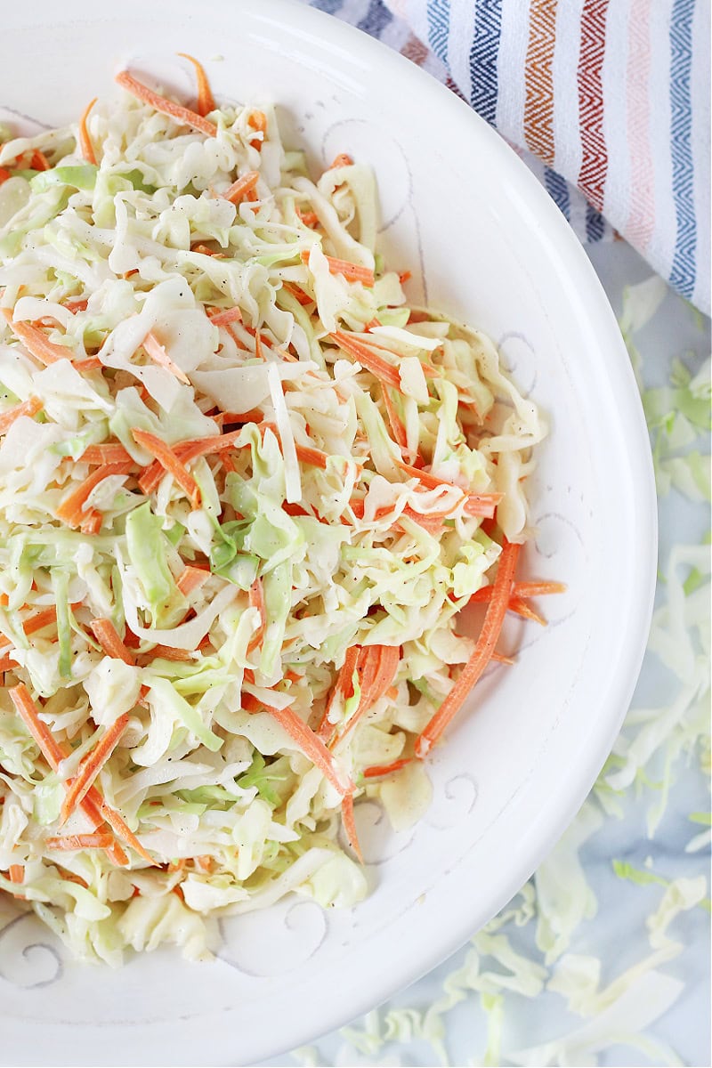 Shredded cabbage and carrots in a homemade coleslaw dressing in a bowl.