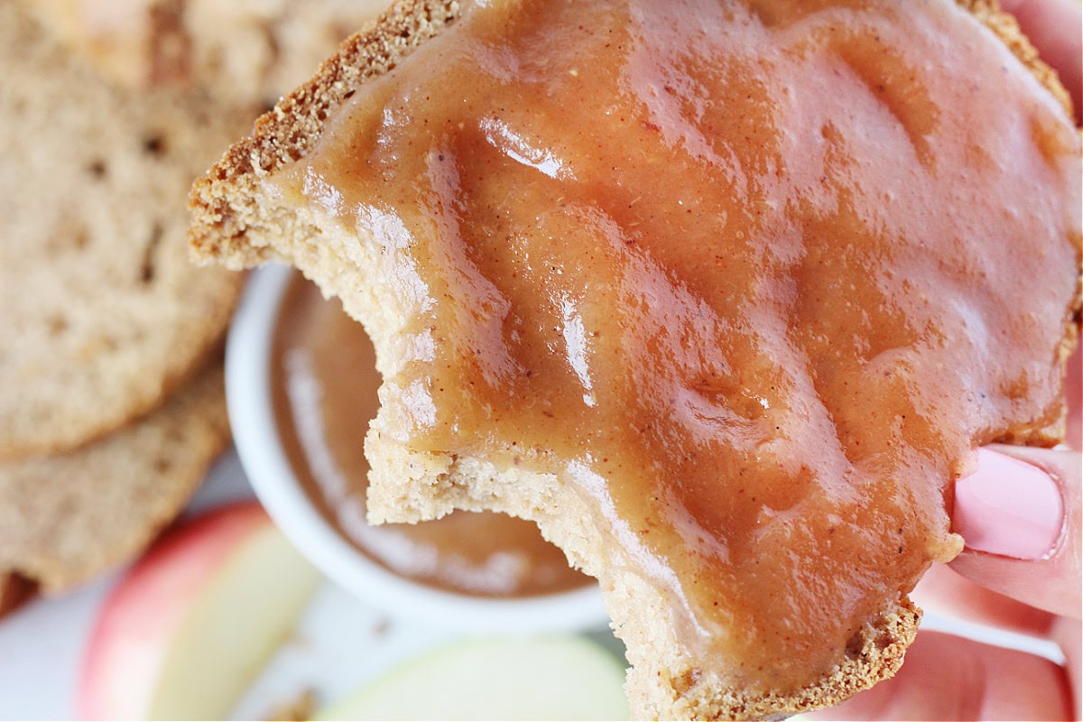 Up close photo of homemade apple butter slathered on a piece of apple butter bread.