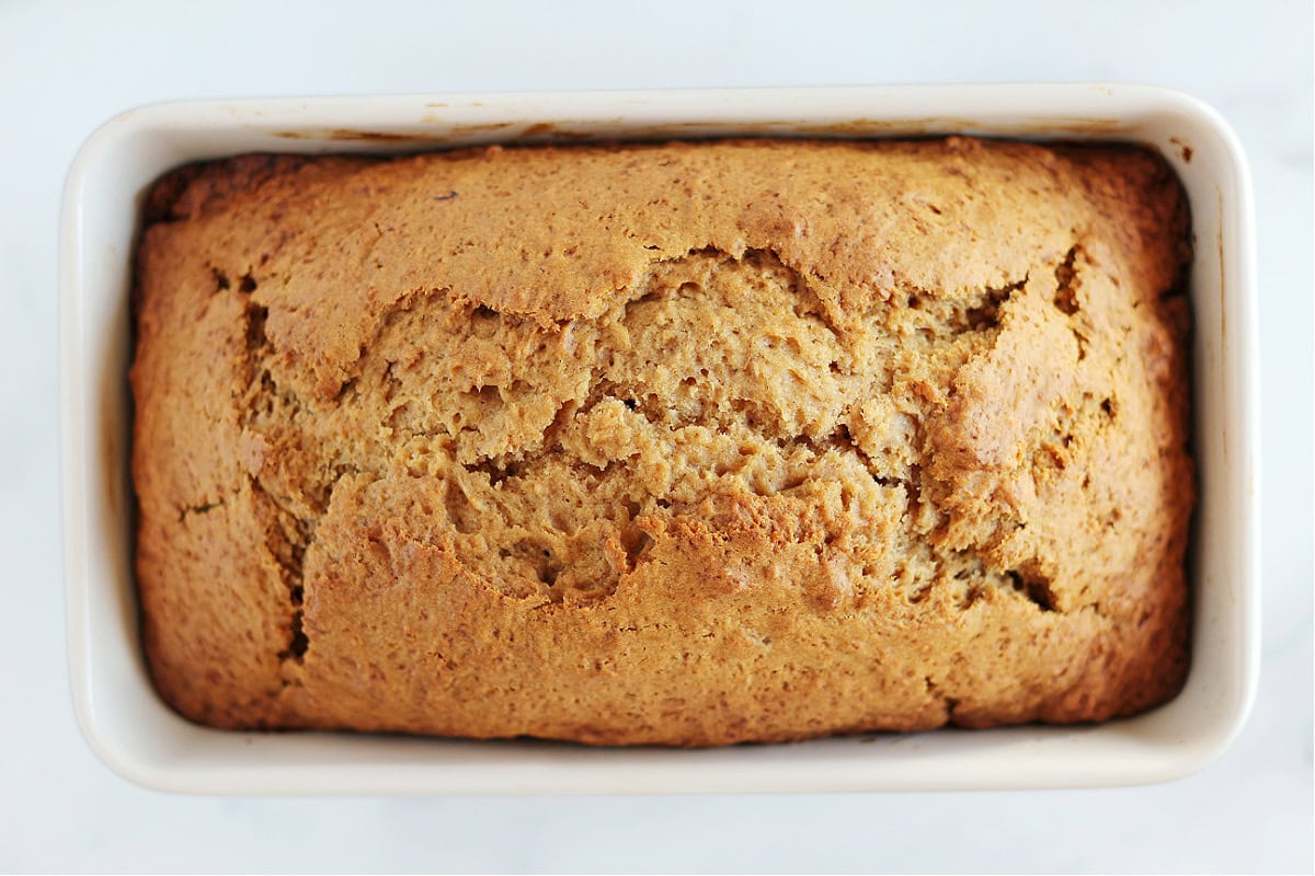 Overhead photo of a baked loaf of quick bread in a metal pan.