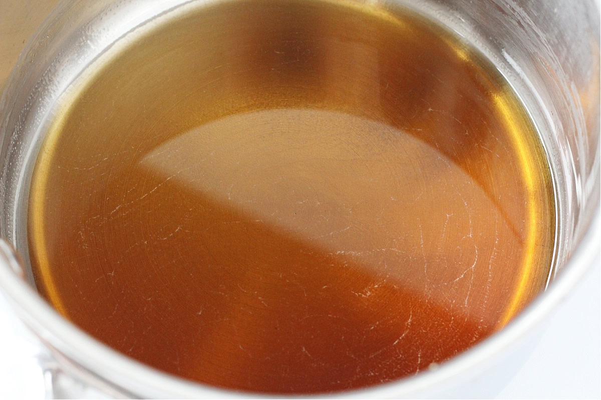 Brown sugar dissolved in water in a stainless steel stovetop pan.