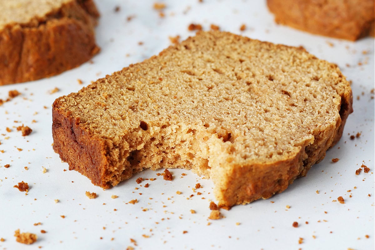 Up close photo of a slice of apple butter bread with a bite taken out.