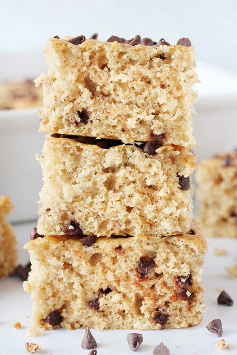 Three healthy banana blondie bites stacked on top of each other.