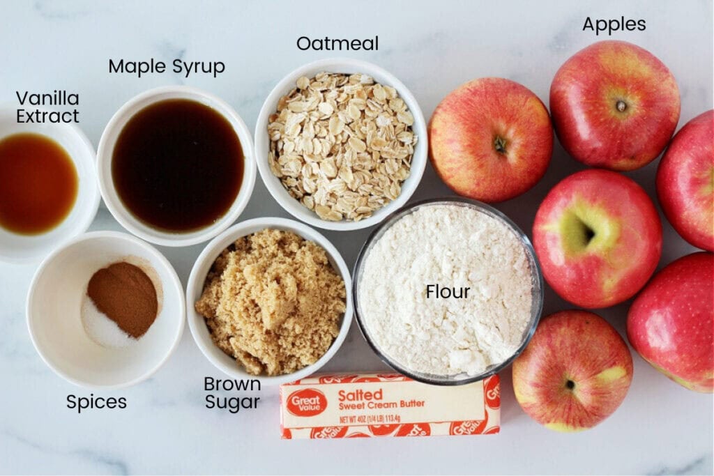 Red apples, rolled oats, flour, butter, maple syrup and spices for easy apple crisp.