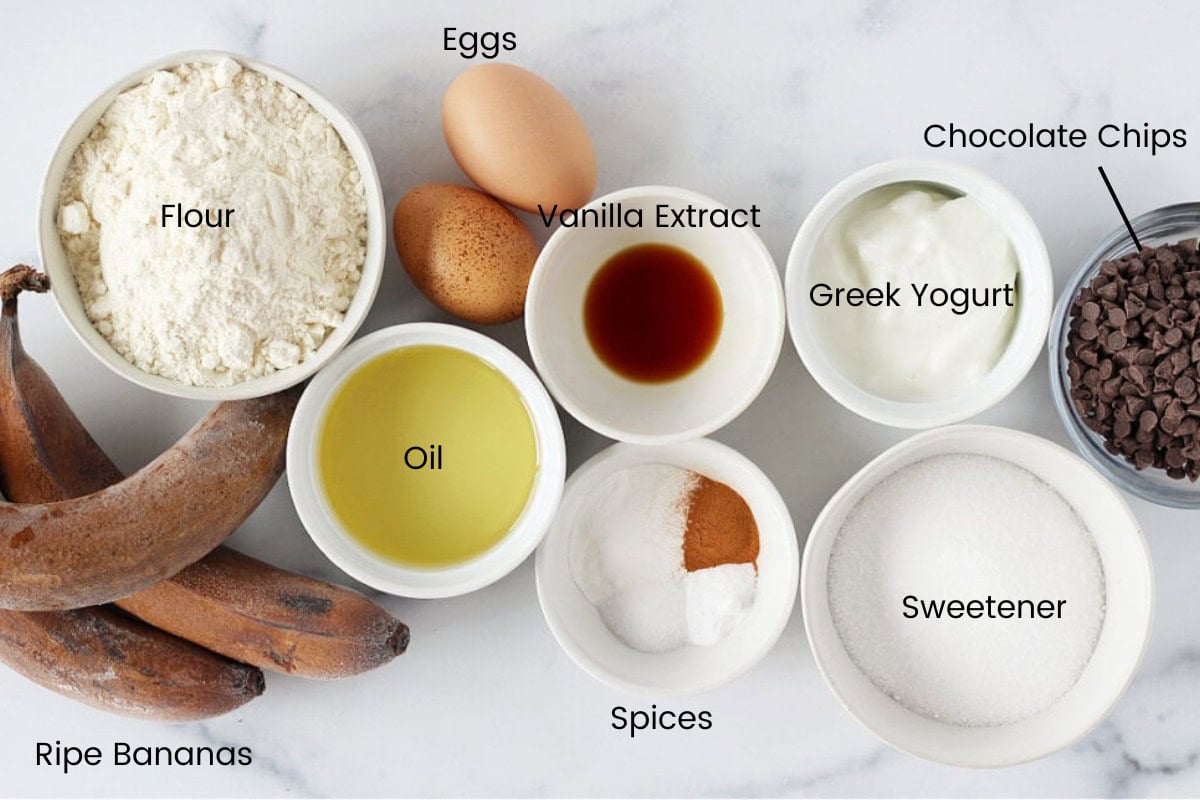 Ingredients for healthy banana blondie bites on a white marble countertop.