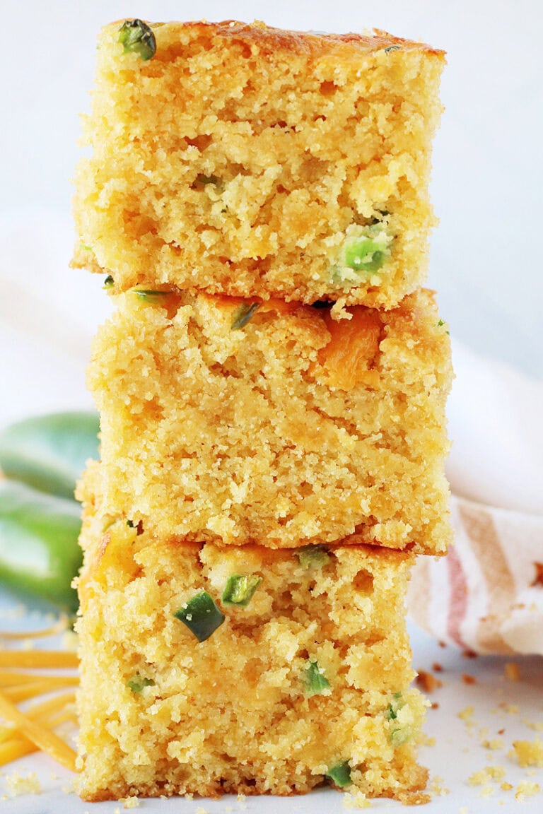 A stack of three jalapeno cheddar cornbread pieces on top of each other.