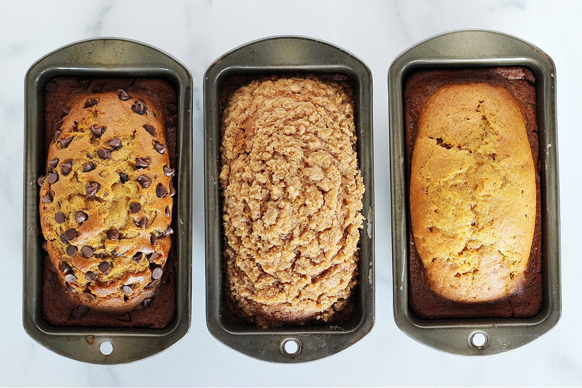 Three different small loaves of pumpkin bread.