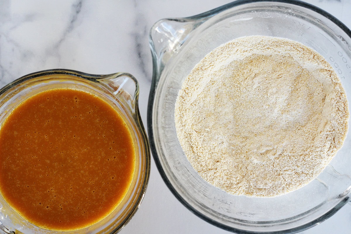 A bowl of wet ingredients with a bowl of dry ingredients.