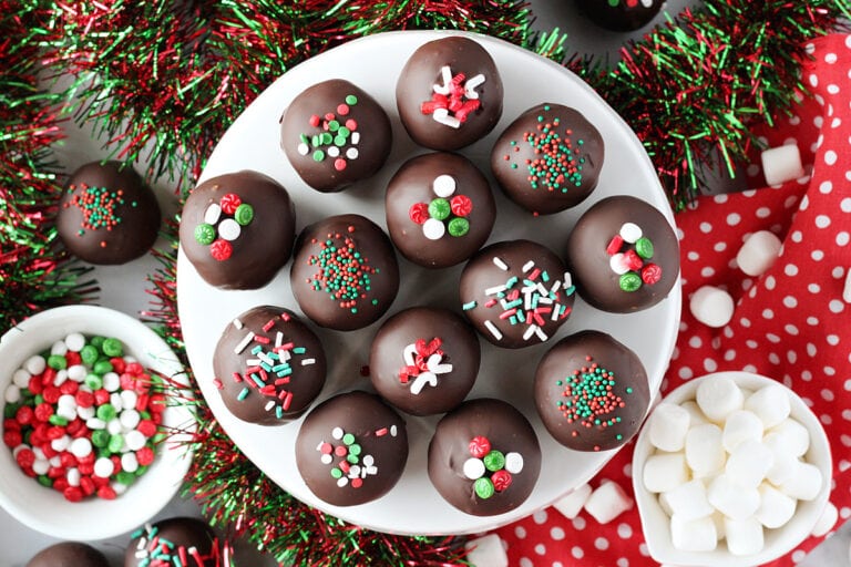 Overhead photo of hot chocolate truffles decorated with different holiday sprinkles.