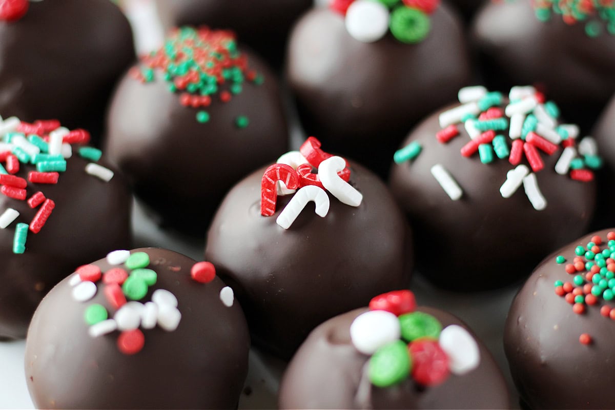 Up close photo of little candy cane candies on top of a hot cocoa truffle.