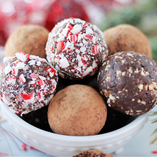 Up close photo of chocolate balls stacked in a white bowl.