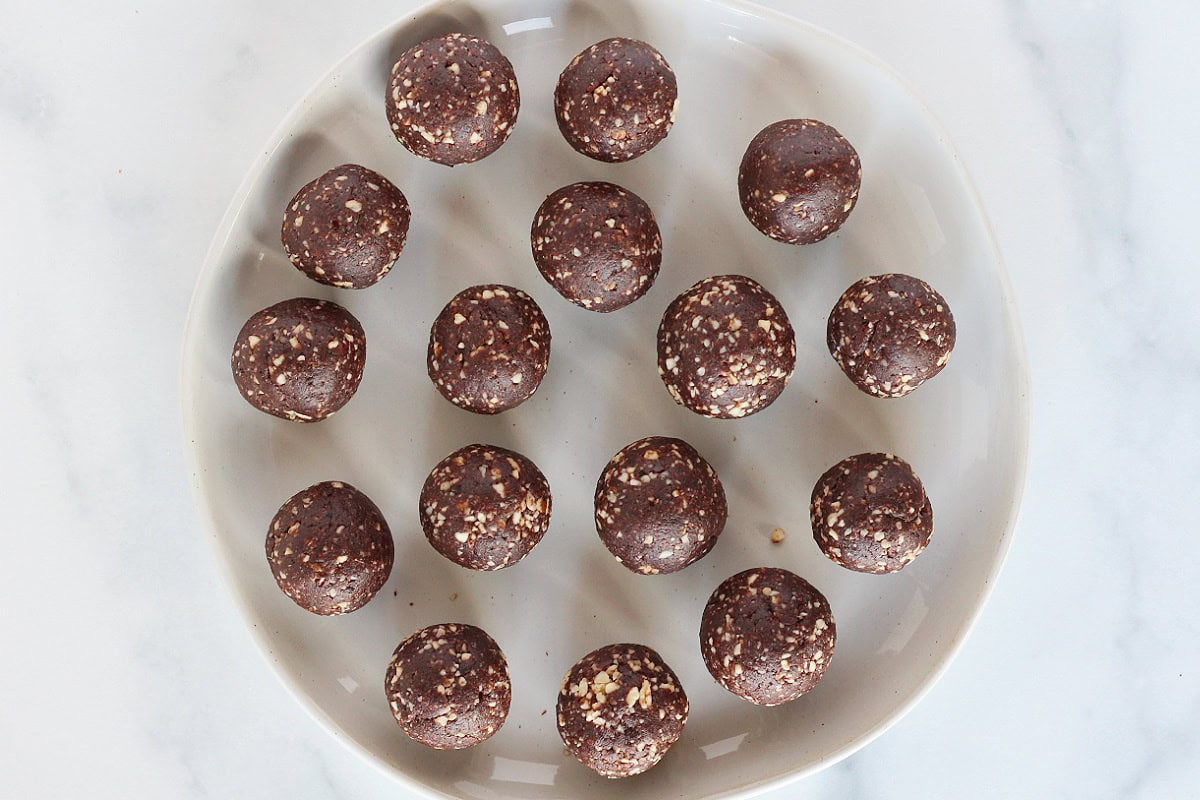 Overhead photo of no bake chocolate mint balls on a white plate.