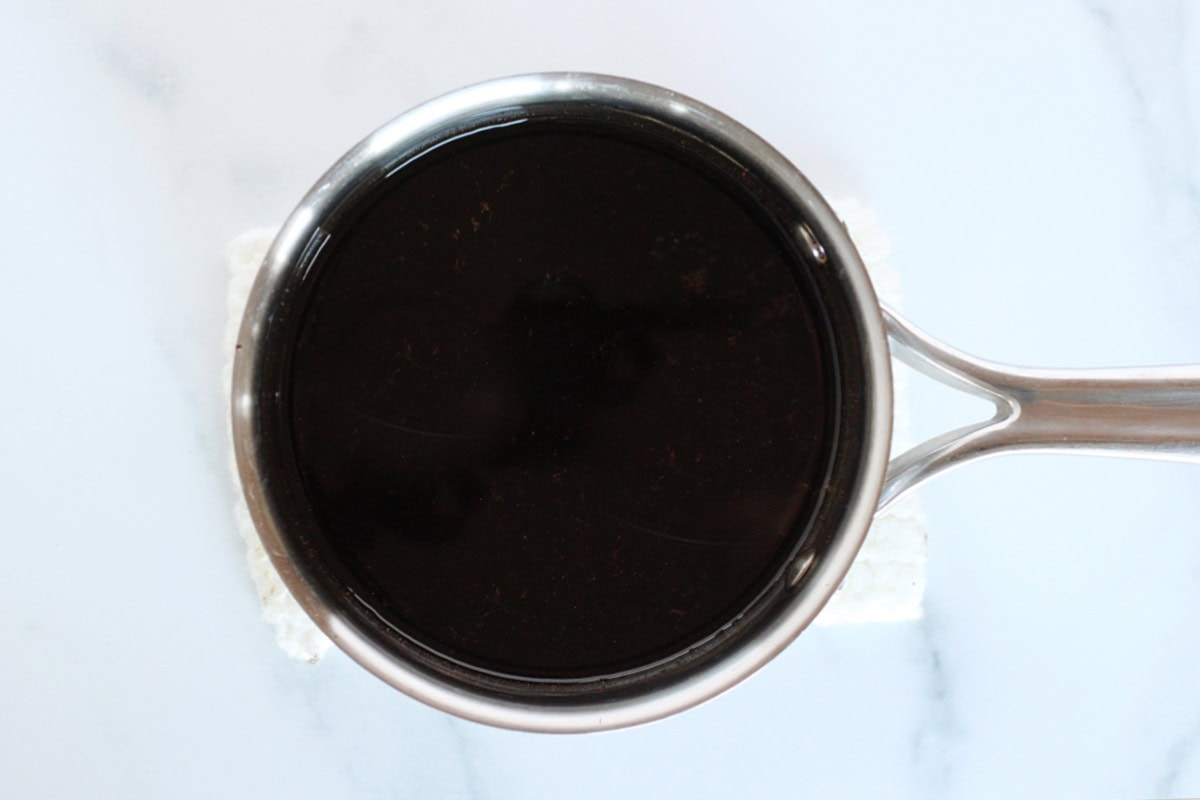 Overhead photo of homemade coffee syrup in a small soup pot.