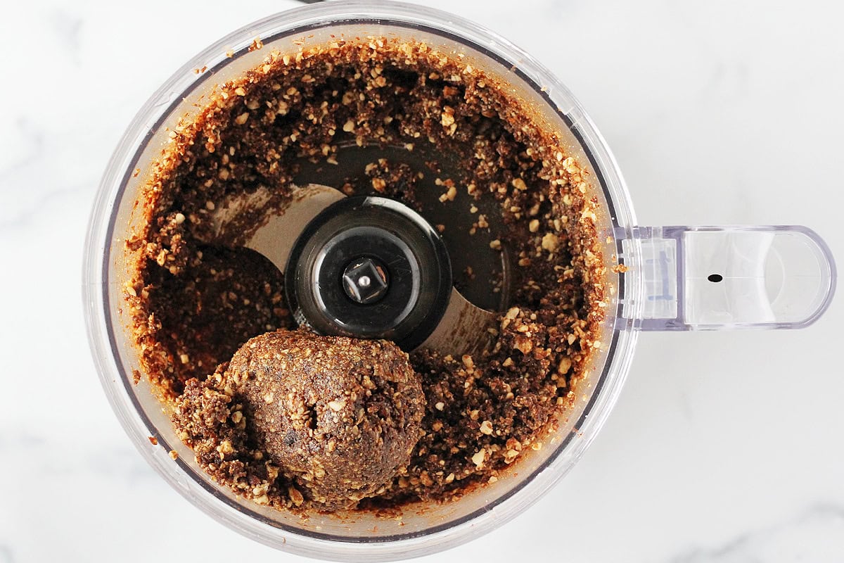 Overhead photo of no bake gingerbread bites batter in a food processor.