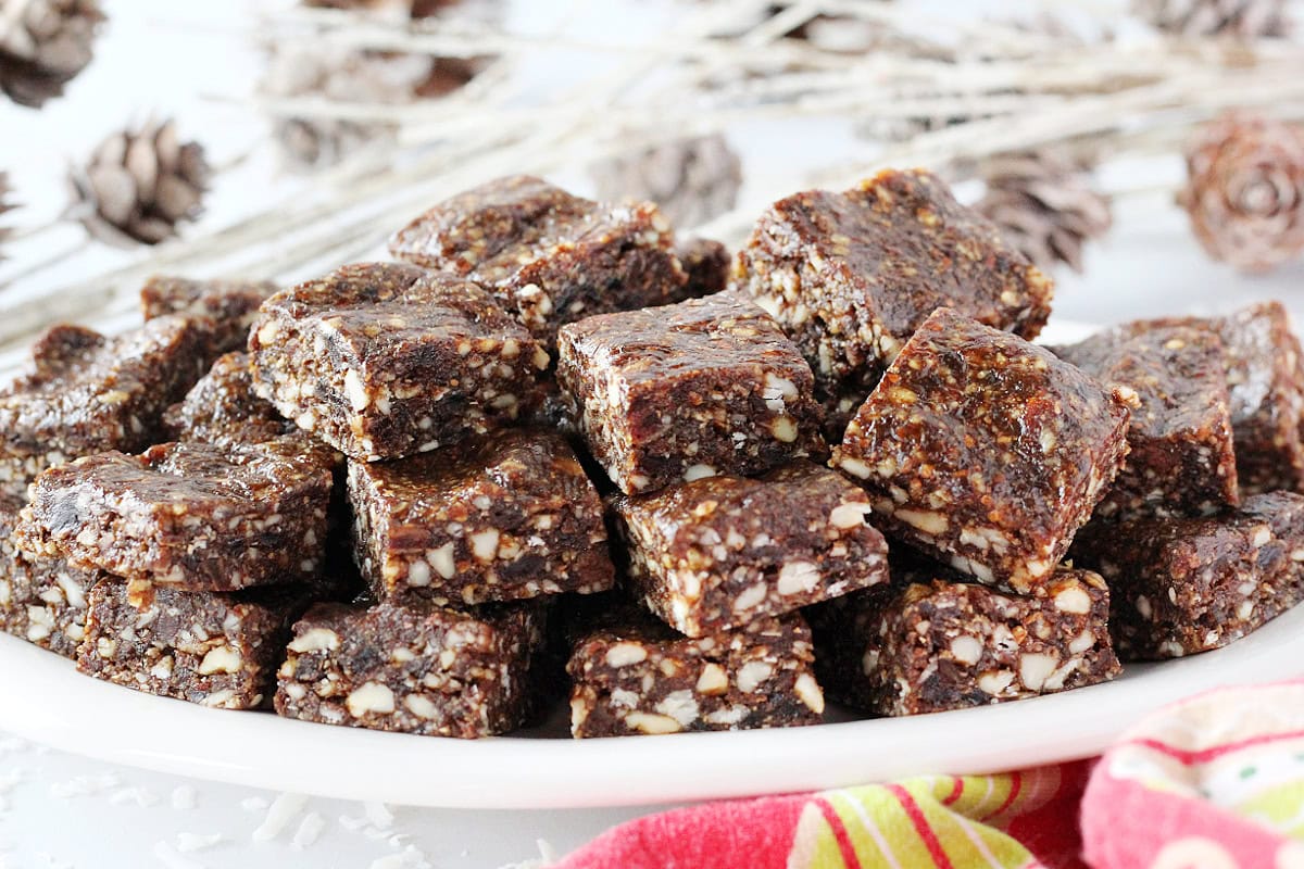 A plate of no bake gingerbread bites stacked three high.