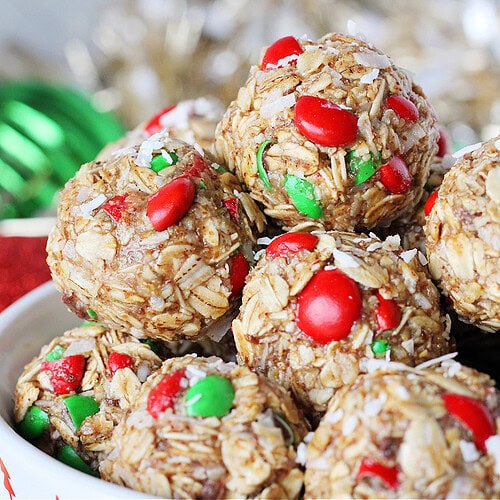 Red and green M&Ms with shredded coconut in holiday energy bites.