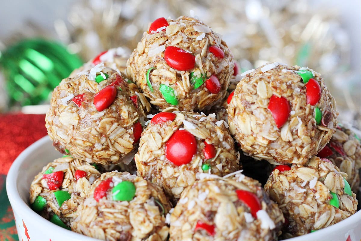 Red and green M&Ms with shredded coconut in holiday energy bites.