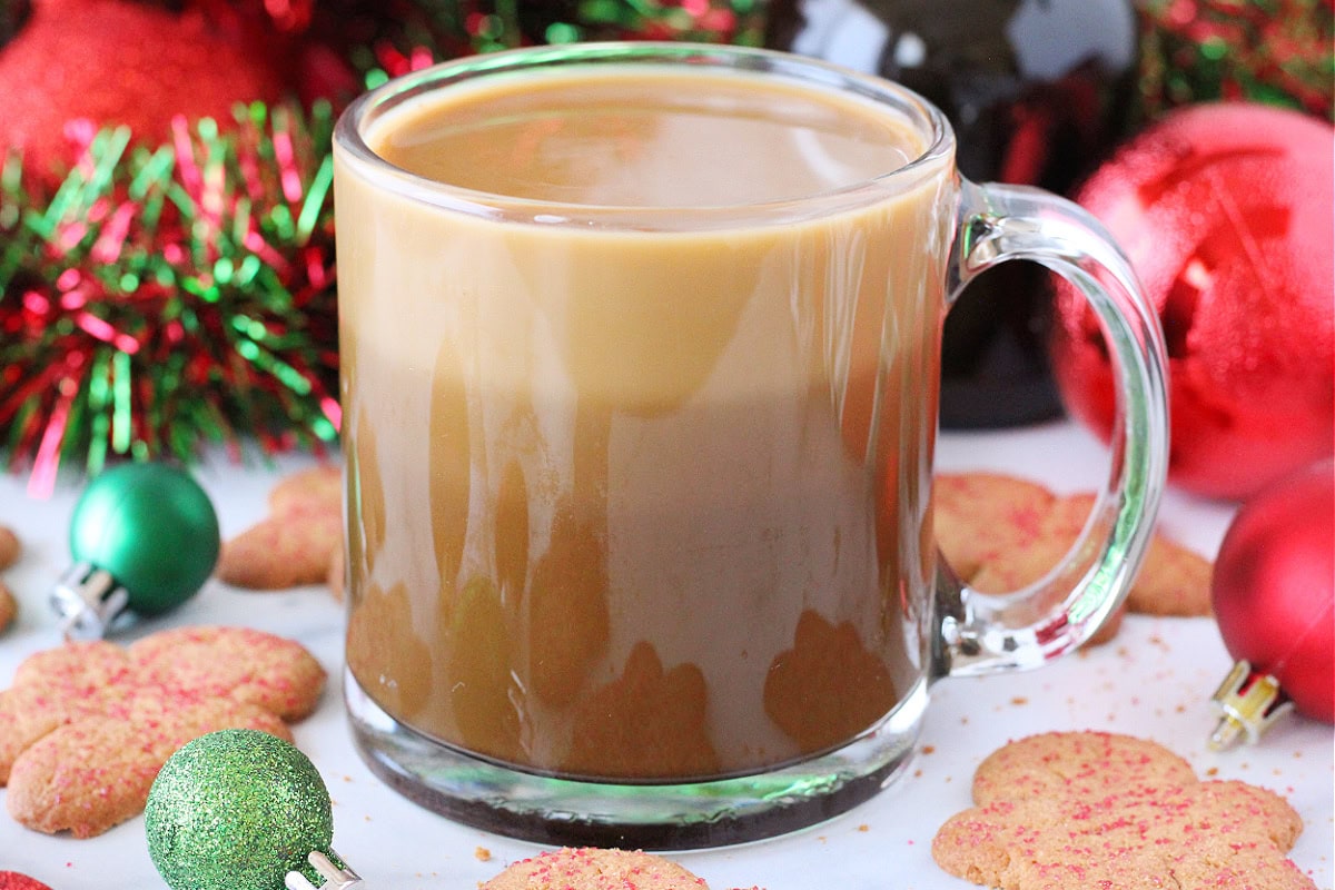 Three layers of Christmas coffee, gingerbread syrup, and half and half in a glass mug.